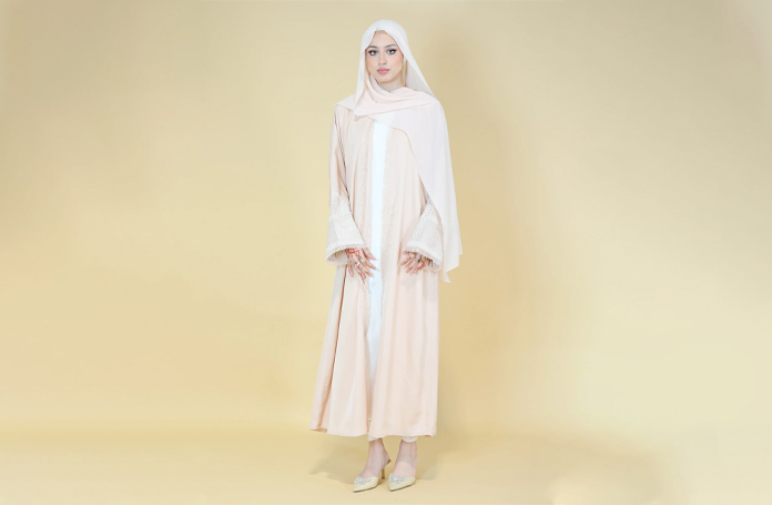 woman wearing beige abaya dress
